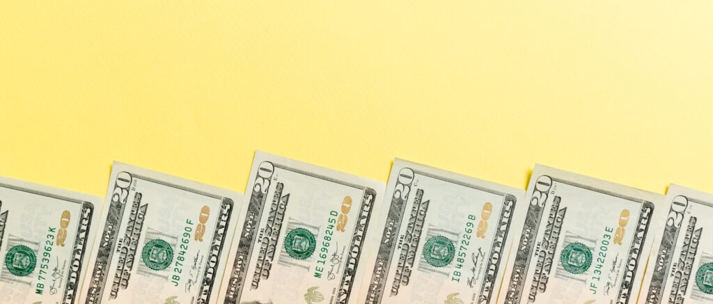 picture of $20 dollar bills with yellow background for an article about How To Get Free Money On Cash App