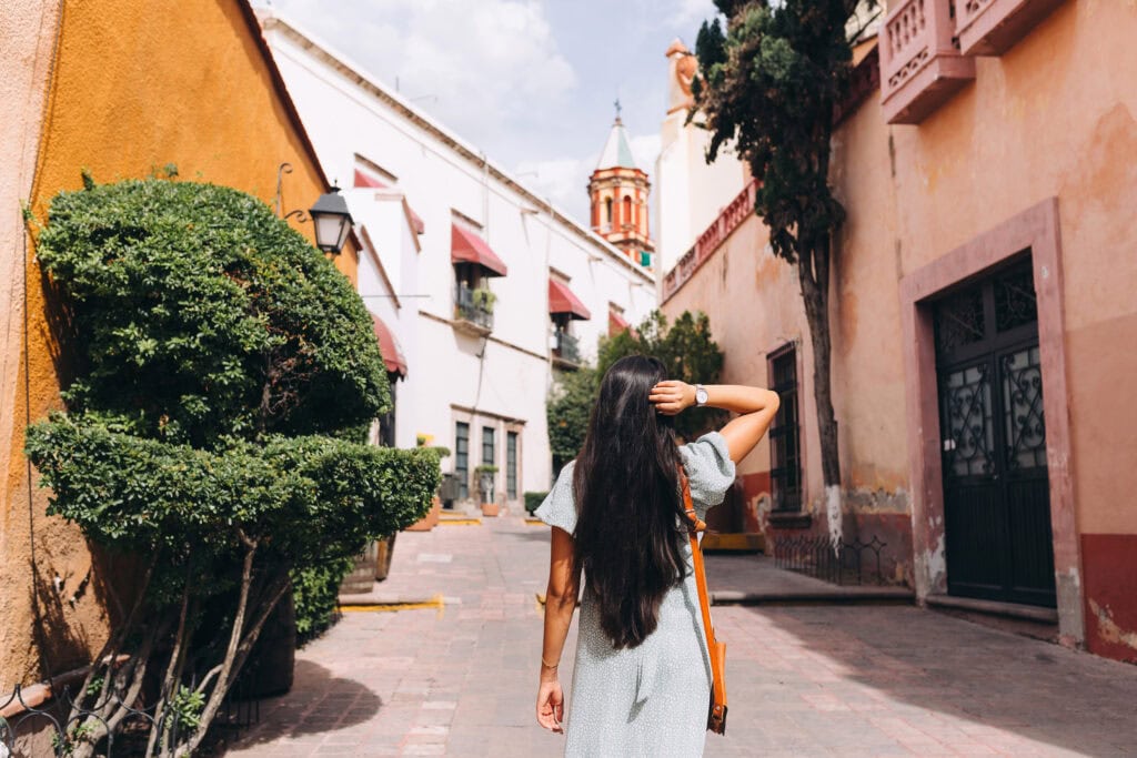 picture of woman walking down touristy street. I want to be my own boss what can I do